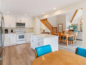 an open kitchen and dining room with a table and chairs at 4160 - Shipley in Kitty Hawk +33 photos