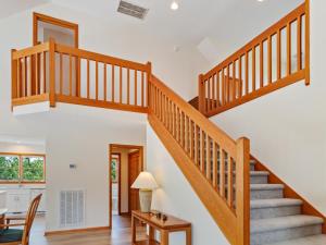 a staircase in a home with white walls and wooden floors at 4160 - Shipley in Kitty Hawk