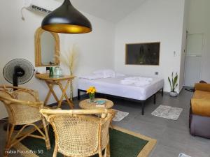 a room with a bed and a table and chairs at Galactic Glow Villa & Resort in Deniyaya