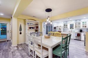 a dining room with a white table and chairs at Sea Colony - 56182 Pine Branch Way in Bethany Beach