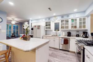 a large kitchen with white cabinets and a counter top at Sea Colony - 56182 Pine Branch Way in Bethany Beach +43 photos