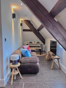 a living room with a couch and a table at The Eaves - Pen Y Fan Views in Brecon