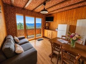 a living room with a couch and a table at Chalet SOL LA MI in Soultzeren