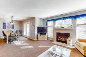a living room with a couch and a fireplace at Sea Colony - 56184 Pine Branch Way in Bethany Beach