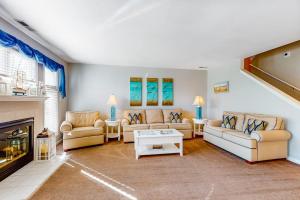 a living room with couches and a fireplace at Sea Colony - 56184 Pine Branch Way in Bethany Beach