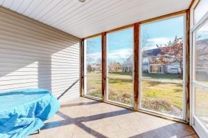 a room with windows and a bed on a patio at Sea Colony - 56184 Pine Branch Way in Bethany Beach