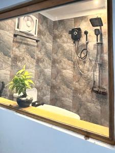 a mirror in a bathroom with a shower at Galactic Glow Villa & Resort in Deniyaya