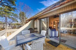 a patio with white chairs and a table on a porch at Sea Colony - 2805 Center Ct in Bethany Beach