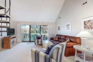 a living room with a leather couch and a tv at Sea Colony - 2805 Center Ct in Bethany Beach