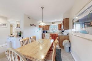 a kitchen with a wooden table and some chairs at Sea Colony - 2805 Center Ct in Bethany Beach +36 photos