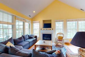 a living room with a couch and a fireplace at Bear Trap Dunes - 2 October Glory in Ocean View