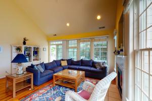 a living room with a blue couch and chairs at Bear Trap Dunes - 2 October Glory in Ocean View +53 photos