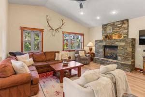 a living room with a couch and a fireplace at 4BR Townhome Near Canyon Lodge & Lakes Basin in Mammoth Lakes +33 photos