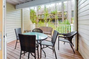 a patio with a table and chairs on a deck at Sea Colony - 1804 Doubles in Bethany Beach