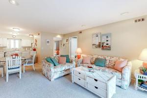 a living room with a couch and a table at Sea Colony - 3306 Round Robin Way in Bethany Beach