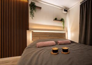 a bedroom with a bed with two candles on it at OffGrid Retreat Rtanj in Boljevac