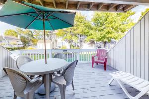 a patio with a table and chairs and an umbrella at Sea Colony - 2008E Brighton Ct in Bethany Beach