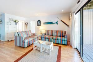 a living room with two couches and a table at Sea Colony - 2008E Brighton Ct in Bethany Beach