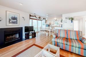 a living room with a couch and a fireplace at Sea Colony - 2008E Brighton Ct in Bethany Beach