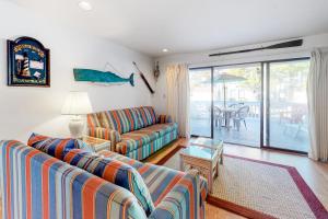 a living room with two couches and a patio at Sea Colony - 2008E Brighton Ct in Bethany Beach