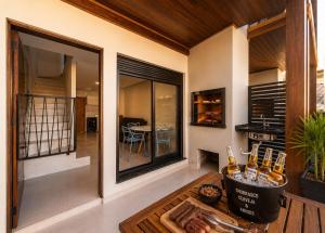 a living room with a table with drinks on it at Pousada Soul Papagaio - lofts completos a 30 metros do mar in Palhoça