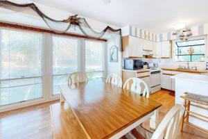 a kitchen with a wooden table and chairs in a room at Sea Colony - 2008E Brighton Ct in Bethany Beach +35 photos