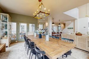 a kitchen and dining room with a wooden table and chairs at Sea Colony - 58011 Wimbledon in Bethany Beach