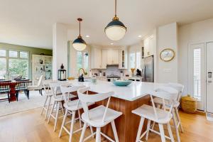 a kitchen and dining room with a large white table and chairs at Sea Colony - 58011 Wimbledon in Bethany Beach