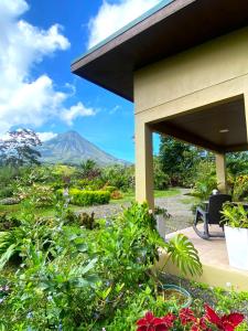 a view from the porch of a house with a mountain in the background at Buganvilia, Cabaña Privada con vista al Volcán Arenal in Palma