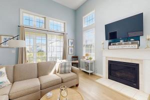 a living room with a couch and a fireplace at Bayside Resort - 36295 Sunflower in Selbyville