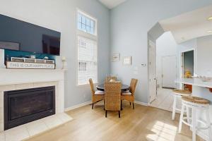 a living room with a fireplace and a table and chairs at Bayside Resort - 36295 Sunflower in Selbyville