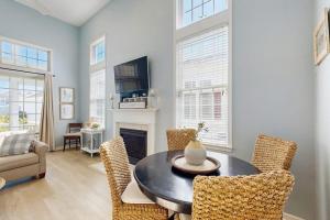 a living room with a table and chairs at Bayside Resort - 36295 Sunflower in Selbyville