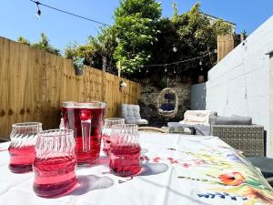 four empty wine glasses sitting on a table at Shrubbery Lodge - Games Room & Patio Dining in Wyke Regis