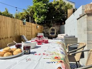 a table with plates of food and drinks on it at Shrubbery Lodge - Games Room & Patio Dining in Wyke Regis