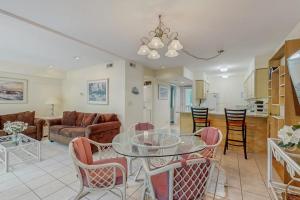 a living room with a glass table and chairs at Sea Colony - 2004 Doubles in Bethany Beach