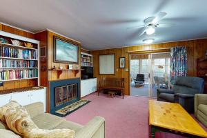 a living room with a fireplace and a couch and chairs at Sea Del Estates - 38 Sugar Hill in Bethany Beach