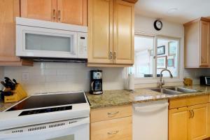 a kitchen with a sink and a microwave at Sea Del Estates - 38 Sugar Hill in Bethany Beach +36 photos