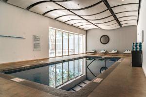an indoor swimming pool with a ceiling with windows at Holiday Inn Guadalajara Patria-Universidad by IHG in Guadalajara +148 photos