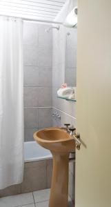 a bathroom with a sink and a shower curtain at Hotel Internacional in San Carlos de Bariloche