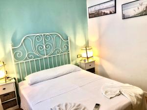 a bedroom with a white bed with two night stands at Vilasardemarlux1 in Vilassar de Mar
