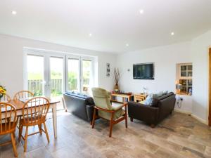 a living room with a couch and a table at Farm Cottage in Cemaes Bay