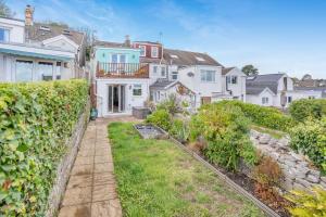 a row of white houses with a yard at 3 Bed in Mumbles oc-m33090 in The Mumbles