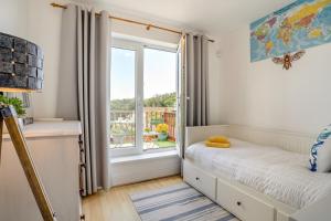 a small bedroom with a bed and a window at 3 Bed in Mumbles oc-m33090 in The Mumbles