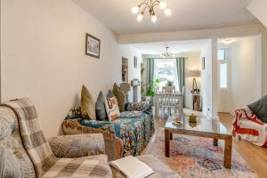 a living room with two couches and a table at 3 Bed in Mumbles oc-m33090 in The Mumbles