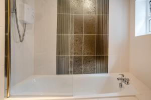 a bathroom with a shower and a bath tub at 3 Bed in Mumbles oc-m33090 in The Mumbles +19 photos