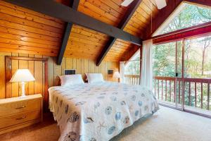 a bedroom with a bed and a large window at Bethany West - 609 Brookview in Bethany Beach