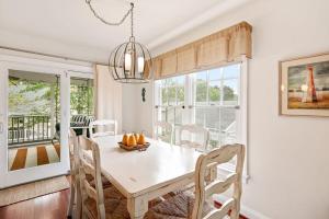 a dining room with a white table and chairs at Bethany West -- 719 Fenwood in Bethany Beach