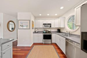 a kitchen with white cabinets and a sink at Bethany West -- 719 Fenwood in Bethany Beach +24 photos