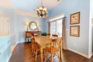 a dining room with a wooden table and chairs at Bear Trap Dunes - 58D October Glory in Ocean View