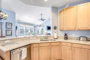 a kitchen with wooden cabinets and a sink at Bear Trap Dunes - 58D October Glory in Ocean View +30 photos